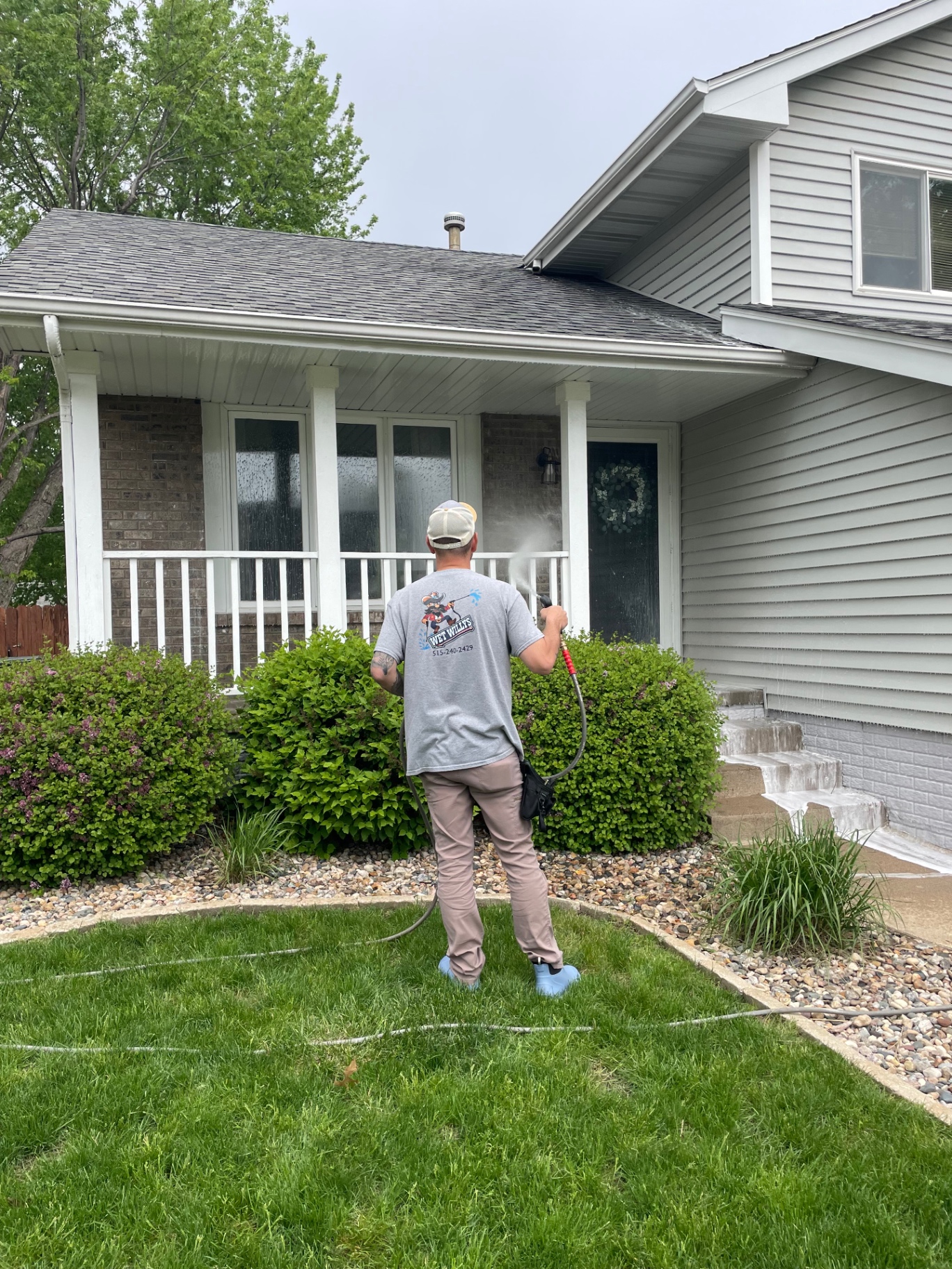 Wet Willys pressure washing a home exterior